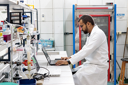 Imagem: Pesquisador operando um notebook no balcão de um laboratório de pesquisa (Foto: Viktor Braga/UFC)