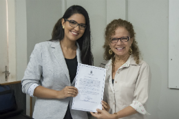 Imagem: Pró-Reitora Adjunta de Gestão de Pessoas, Profª Cláudia Buhamra, entrega termo de posse à servidora Priscilla Guerra (Foto: Viktor Braga/UFC)