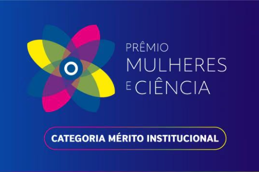 Imagem: Imagem com fundo azul em degradê e um ícone central colorido, formado por pétalas sobrepostas em tons de amarelo, rosa, azul e cinza, com um círculo no meio, simbolizando um olho. O texto principal diz: "Prêmio Mulheres e Ciência" e logo abaixo, dentro de uma caixa com bordas amarelas, lê-se "Categoria Mérito Institucional". 